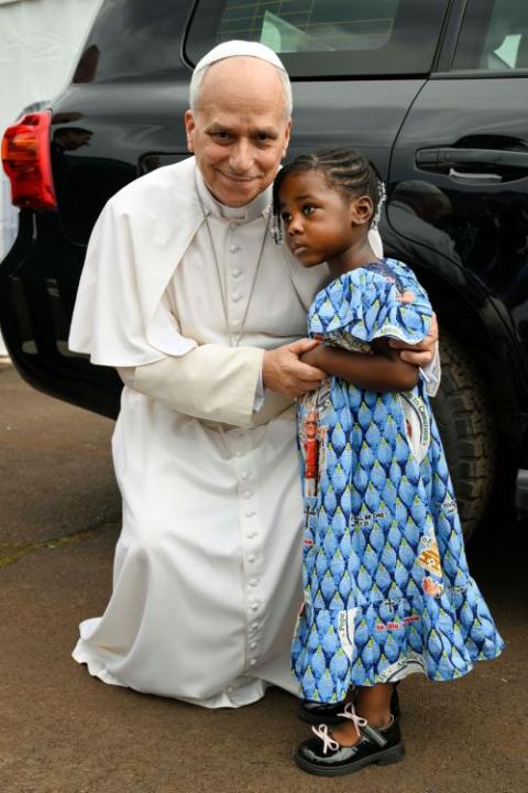 Pope Leo XIV embraces a girl during his pastoral visit to Bamenda, Cameroon April 16, 2026.That day the pontiff attended a Meeting for Peace and celebrated Mass. (OSV News/Vatican Media/Simone Risoluti)