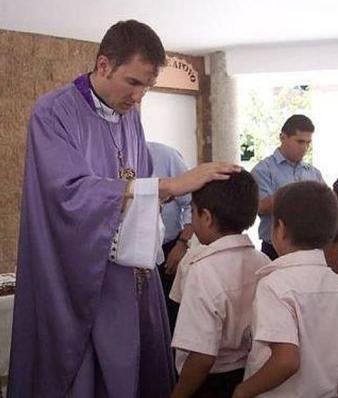 Then-Fr. Ronald A. Hicks is pictured in an undated photo blessing children during an Ash Wednesday Mass while he was based in El Salvador from 2005 to 2010 as regional director of Nuestros Pequeños Hermanos, working to help vulnerable and impoverished children. (OSV News/Courtesy of Catholic Extension)