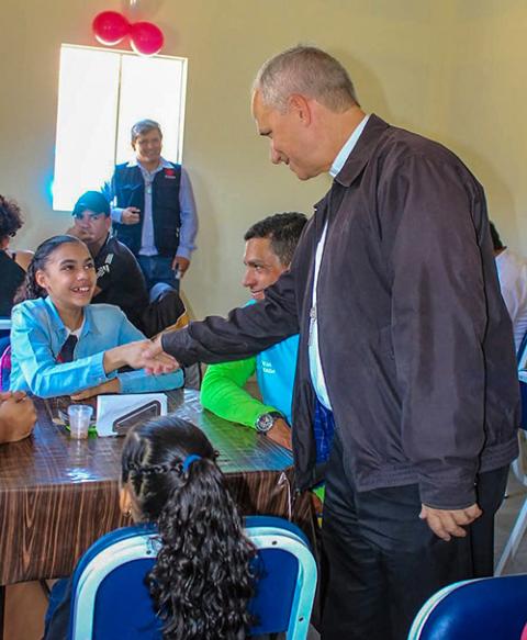 Then-Bishop Robert Prevost of Chiclayo, Peru, greets a member of his flock in an undated photo. (OSV News/Courtesy of Caritas Chiclayo, via Janina Sesa, former director)