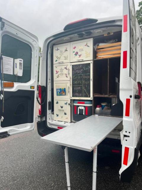 The Capuchin Mobile Ministries van visits seven sites three times a week in the Boston area. People can get a snack, a pair of socks or conversation. (Greta Gaffin)