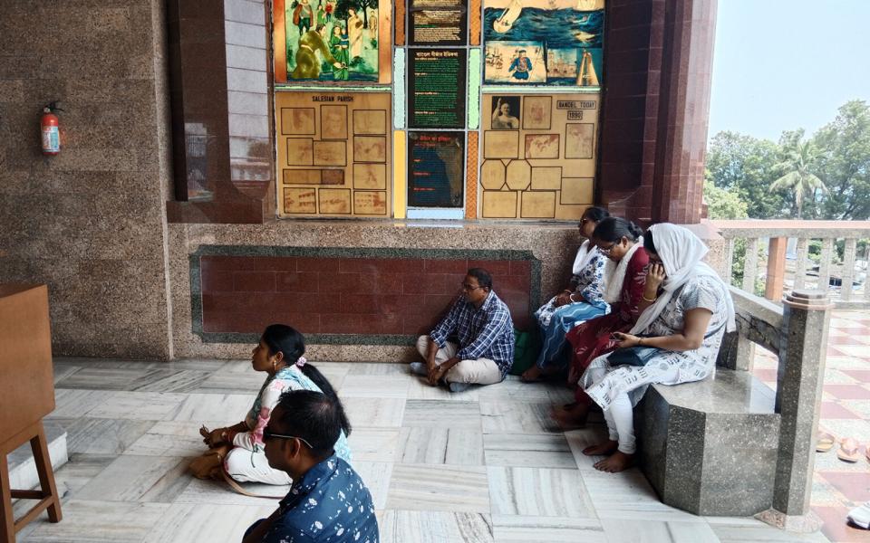 Devotees pray at the Basilica of the Holy Rosary, locally known as the Bandel Church
