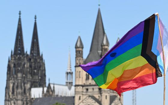 A rainbow flag is seen near the spires of the Cologne Cathedral on July 9, 2023. (OSV News photo/Jana Rodenbusch, Reuters)