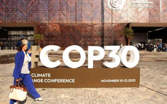 Woman walks near sign for COP#).