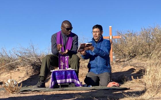 Two unidentified Jesuit priests concelebrate Mass in the Chihuahuan Desert in New Mexico Dec. 21, 2025, for a 20-year-old Guatemalan woman whose remains were previously recovered in the area marked by the cross, and also for two women whose remains were found Dec 19. (OSV News/Courtesy of Collin Price)