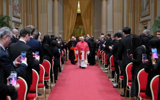Pope Leo XIV walks down the aisle to meet with members of the diplomatic corps accredited to the Vatican at the Apostolic Palace at the Vatican Jan. 9, 2026. (CNS/Vatican Media)