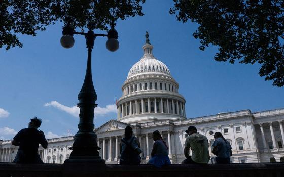Visitors to the U.S. Capitol rest in the shade on Capitol Hill in Washington June 25, 2025. (OSV News/Reuters/Nathan Howard)