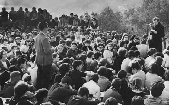 Msgr. Luigi Giussani, founder of the lay movement Communion and Liberation, meets with students in 1963. (OSV News file/Courtesy of Communion and Liberation)