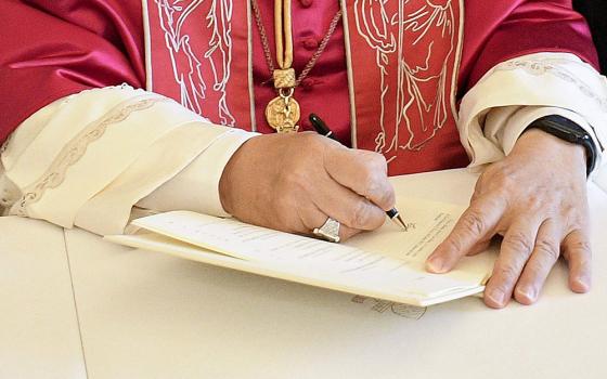 Pope Leo XIV signs his first apostolic exhortation, Dilexi Te ("I Have Loved You"), in the library of the Apostolic Palace at the Vatican Oct. 4, 2025, the feast of St. Francis of Assisi. His first encyclical, Magnifica Humanitas, will be published May 25, 2026, addressing artificial intelligence and the protection of human dignity, the Vatican announced May 18, 2026. (OSV News/CPP/Vatican Media)