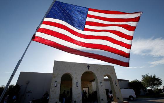 A file photo shows a U.S. flag outside Mary Immaculate Catholic Church in Dallas. Two-thirds of U.S. adults who regularly attend religious services have heard their clergy speak about at least one political or social issue recently, according to a new Pew Research Center survey. (OSV News/Reuters/Carlo Allegri)