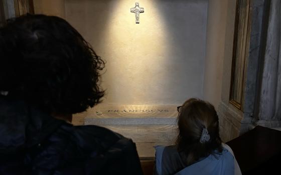 Pilgrims gather around the tomb of Pope Francis along the side of the Basilica of St. Mary Major in Rome. (NCR photo/Justin McLellan)