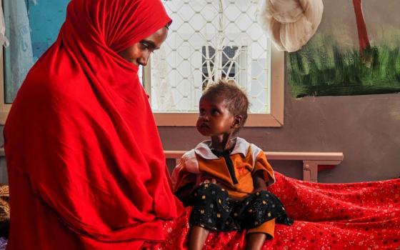 A mother looks at her daughter, who is suffering from severe acute malnutrition, at a stabilization center in a hospital in Qardho, Puntland, Somalia, April 17, 2026. (AP/Jack Denton)