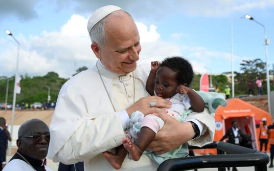 Pope Leo XIV holds a baby at the Sanctuary of Our Lady of Muxima in Muxima, Angola, April 19, 2026. (OSV News/Vatican Media/Simone Risoluti)
