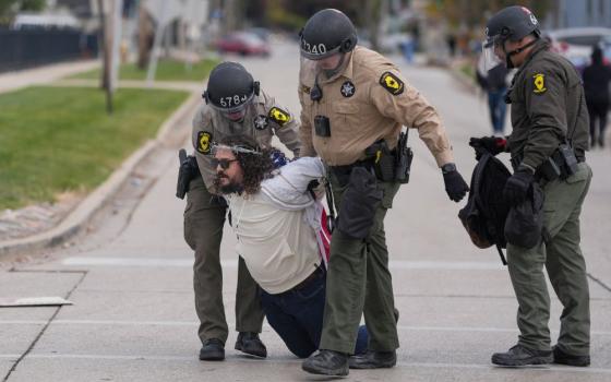 A demonstrator is detained by law enforcement during a protest near the Broadview ICE facility in Chicago Nov. 1, 2025. (OSV News/Reuters/Leah Millis)