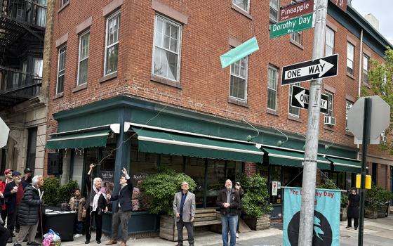 Martha Hennessy, Dorothy Day's granddaughter, and Councilman Lincoln Restler unveil the Dorothy Day Way sign in Brooklyn Heights on May 2. (NCR Photo/Camillo Barone)