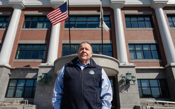 Thomas Koch, mayor of Quincy, Mass., stands in front of the city's new public safety headquarters building where he wants to place two saint statues. (Courtesy of Becket Fund)