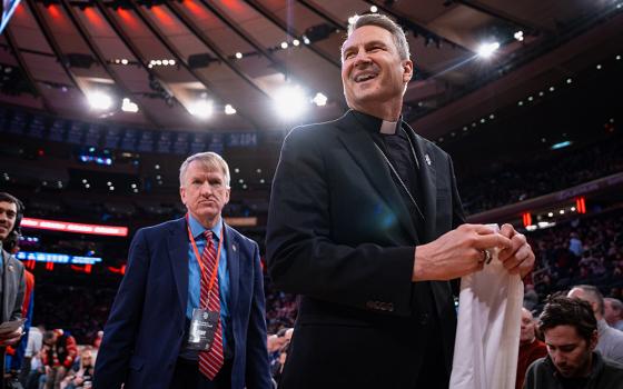 New York Archbishop Ronald Hicks smiles after receiving a "Hicks" St. John's jersey during a timeout at an NCAA college basketball game against Xavier, Feb. 9, 2026, in New York. (AP photo/Angelina Katsanis)