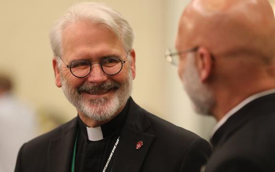 Archbishop Paul S. Coakley of Oklahoma City, now president of the U.S. Conference of Catholic Bishops, and Bishop James S. Wall of Gallup, New Mexico, share a light moment during a break June 16, 2023, at the bishops' spring plenary assembly in Orlando, Florida. The conference's 2026 spring assembly will be held in Orlando June 10-12, with public sessions scheduled for June 10 and 11. (OSV News/Bob Roller)