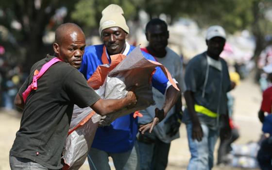 Workers distribute shelter kits assembled by Catholic Relief Services at a camp for survivors of the 2010 earthquake in Port-au-Prince, Haiti. The U.S. Department of State announced June 5, 2026, that a $240 million grant in humanitarian and disaster response assistance — the first of a series of such grants — will be made to CRS, the overseas relief and development arm of the U.S. Catholic Church. (OSV News/Bob Roller)