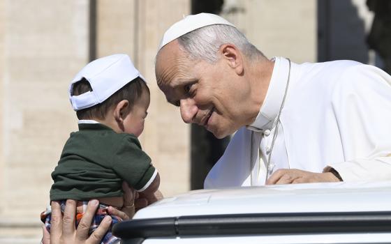 Pope Leo XIV greets a child from the popemobile while riding around St. Peter’s Square at the Vatican before his weekly general audience June 24, 2026. (CNS/Vatican Media)