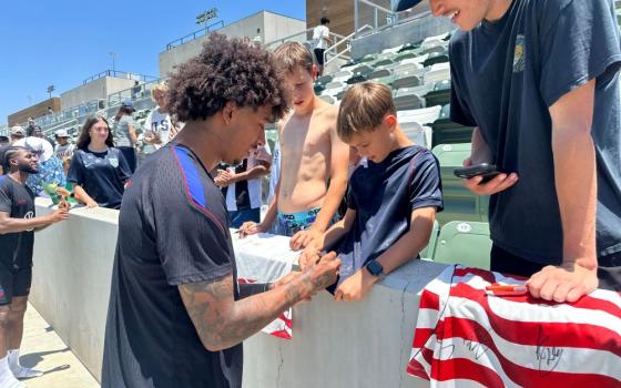 United States defender Chris Richards, front left, gives autographs to fans after the national team's first practice at its World Cup soccer tournament training base in Irvine, Calif., June 8, 2026. The international tournament begins July 11. (AP/Greg Beacham)