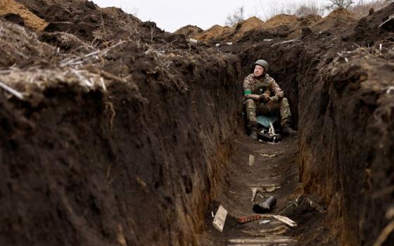 A Ukrainian soldier listens to artillery fire from his bunker at a front-line position near Bakhmut March 16, 2023, amid Russia's attack on Ukraine. (OSV News/Reuters/Violeta Santos Moura)