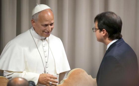 Pope Leo XIV speaks with to Christopher Olah, co-founder of the artificial intelligence company Anthropic, at the conclusion of a presentation on the pope's first encyclical, "Magnifica Humanitas: On Safeguarding the Human Person in the Time of Artificial Intelligence," at the Synod Hall at the Vatican May 25, 2026. (CNS/Lola Gomez)