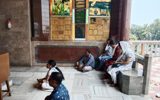 Devotees pray at the Basilica of the Holy Rosary, locally known as the Bandel Church