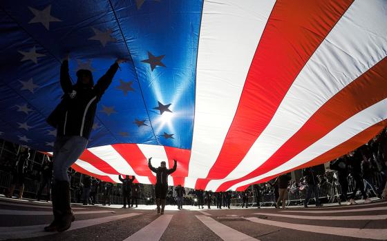In this 2017 file photo, people in New York City carry the U.S. flag. (CNS/Reuters/Eduardo Munoz)