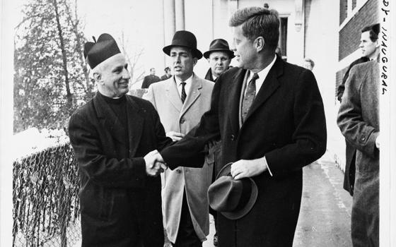 President-elect John F. Kennedy shakes hands with Fr. Richard J. Casey, pastor of Holy Trinity Church, after attending Mass at the church prior to inauguration ceremonies in Washington Jan. 20, 1961. (CNS/Library of Congress Prints and Photographs Division Washington)