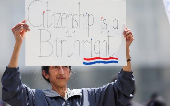 A demonstrator holds a placard during a protest outside the Supreme Court in May 2025. (OSV News/Reuters/Leah Millis)