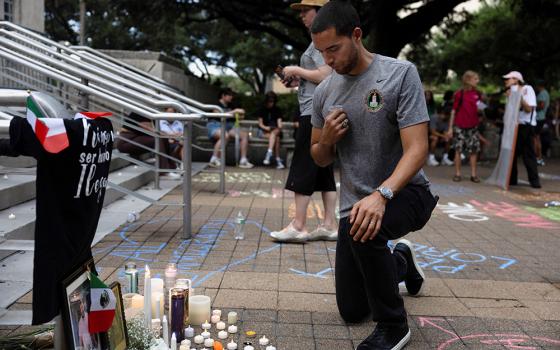 A man makes the sign of the cross at a makeshift memorial during a vigil in Houston July 11, 2026, in response to the fatal shooting of a Mexican motorist by an Immigration and Customs and Enforcement agent during a vehicle stop. (OSV News/Reuters/Antranik Tavitian)