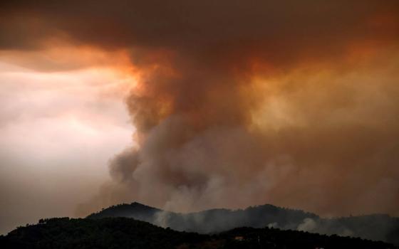 Smoke rises from a wildfire progressing in Betxi, Spain, July 26, 2026. Firefighters continue to battle massive wildfires in Spain and France that have forced hundreds of thousands to evacuate from their homes. (OSV News photo/Pedro Nunes, Reuters)