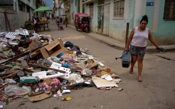A woman carries a portable power charger during a blackout in Havana, Cuba, July 6, 2026. (AP/Ramon Espinosa)