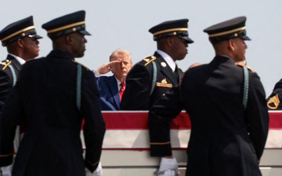 U.S. President Donald Trump salutes as members of the military carry the transfer case of U.S. Army Pvt. Isabella Gonzales during a dignified transfer of her remains at Dover Air Force Base in Delaware July 22, 2026. Gonzales was killed during an attack at Muwaffaq Salti Air Base in Jordan. (OSV News/Reuters/Evelyn Hockstein)