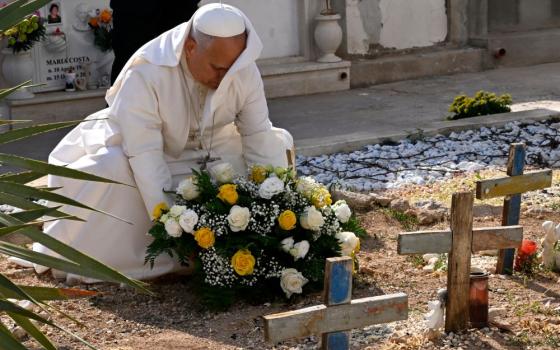 Pope Leo XIV pays tribute at the cemetery and on little Joussef's grave, in Lampedusa, Sicily, southern Italy, Saturday, July 4, 2026, during a one-day pastoral visit to an island that has become a symbol of the risks faced by migrants trying to reach Europe by sea. (Pool photo/Ciro Fusco, via AP)