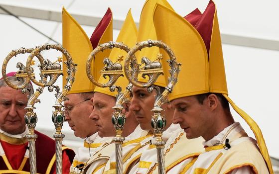 Newly consecrated Society of St. Pius X bishops, from left, Pascal Schreiber, Michael Goldade, Michel Poinsinet de Sivry and Marc Hanappier pray at the end of their consecration ceremony in a tent set up outside the Society of St. Pius X seminary in Écône, Switzerland, July 1, 2026. (AP/Baz Ratner)