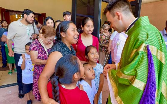 Fr. Mattia Ferrari, right, greets parishioners after celebrating Mass at Our Lady of Guadalupe Church, on June 21, 2026, in Mecca, Calif. (Courtesy of Catholics in Communion)