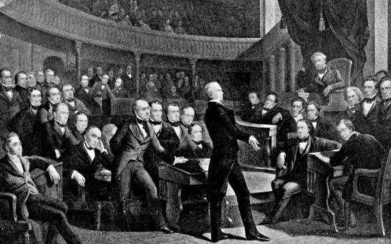 A 1900 illustration depicts the U.S. Senate in 1850, as Sen. Henry Clay delivers a speech. Seated in the second row behind him is Daniel Webster, and on the far right is John Calhoun.